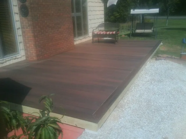 Freshly stained wood deck built against a brick home in Yerington